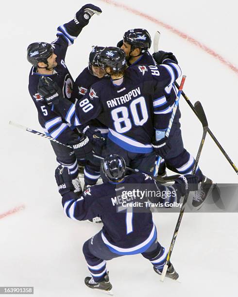 Derek Meech of the Winnipeg Jets joins teammates Mark Stuart, Kyle Wellwood, Nik Antropov and Dustin Byfuglien to celebrate a second period goal...