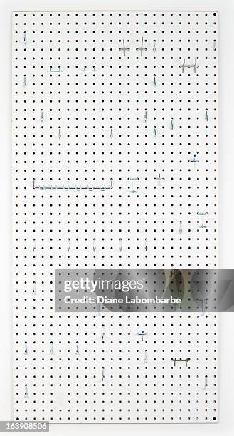empty pegboard with hooks for organizing - pegboard stock pictures, royalty-free photos & images