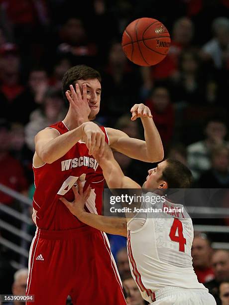 Aaron Craft of the Wisconsin Badgers hits Frank Kaminsky of the Ohio State Buckeyes during the Big Ten Basketball Tournament Championship game at...