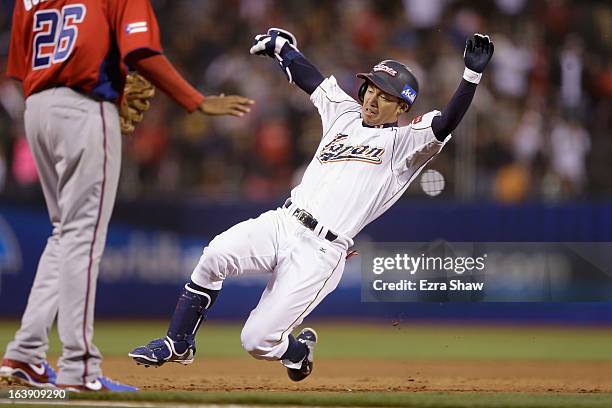 Takashi Toritani of Japan slides safely in to third base for a triple in the eighth inning against Puerto Rico in the semifinals of the World...