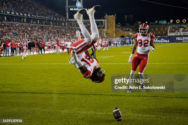 Luther Hakunavanhu of the Calgary Stampeders does a back flip after scoring a touchdown on a pass reception against the Toronto Argonauts during the...