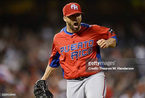 Pitcher J.C. Romero of Team Puerto Rico reacts after getting Shinnosuke Abe of Team Japan to ground out to second base for the third out of the...