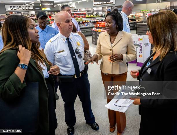 Suzette Stevenson, Director of Asset Protection for Giant Foods, center right, talks with Lindsey Appiah, left, Deputy Mayor for Public Safety and...