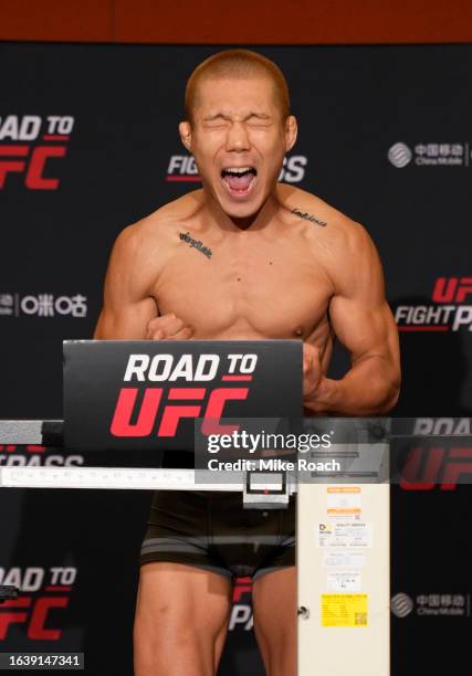 SangWon Kim of South Korea poses on the scale during the Road to UFC weigh-in at Resorts World Convention Centre on August 26, 2023 in Singapore.