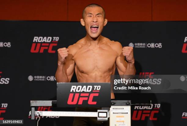 Sangwook Kim of South Korea poses on the scale during the Road to UFC weigh-in at Resorts World Convention Centre on August 26, 2023 in Singapore.