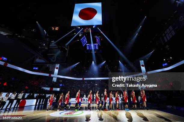 Team Japan lines up for the national anthem prior to the FIBA World Cup Group E game between Germany and Japan at Okinawa Arena on August 25, 2023 in...