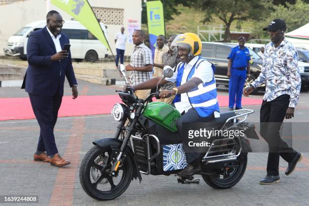 Kenya's President William Ruto uses an electric motorcycle during the national launch of an electric motorcycle project dubbed e-bodaboda at Kenyan...