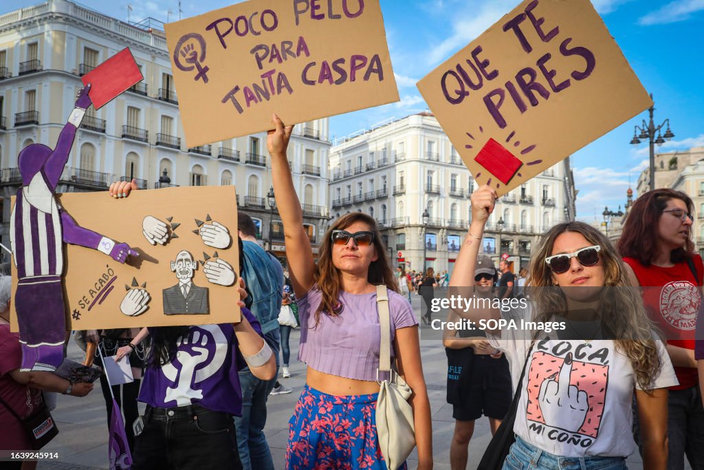 Protesters hold placards with feminist and anti-machismo...