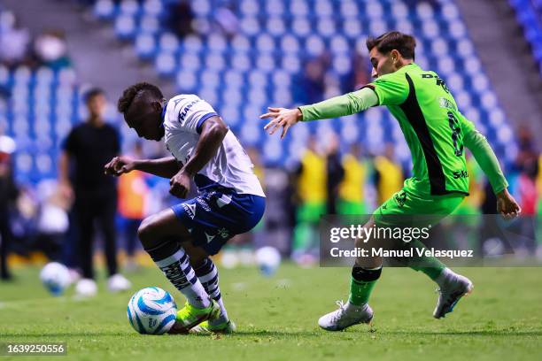 Kevin Velasco of Puebla battles for the ball against Sebastián Pérez Bouquet of Juarez FC during the 6th round match between Puebla and FC Juarez as...