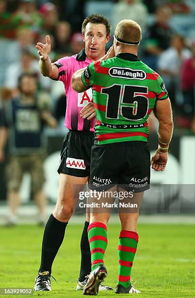 Referee Jared Maxwell talks with Rabbitohs captain Michael Crocker during the round two NRL match between the South Sydney Rabbitohs and the Cronulla...