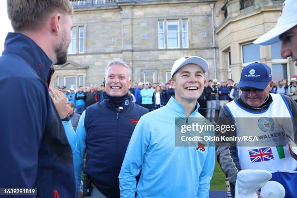 Connor Graham of Great Britain and Ireland reacts with Great Britain & Ireland Captain Stuart Wilson on the 1st tee during the Saturday Foursomes on...