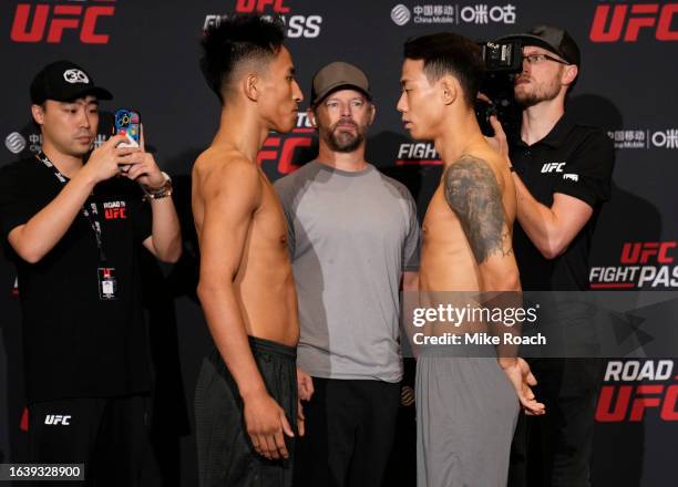 Opponents Jiniushiyue of China and SeungGuk Choi of South Korea face off during the Road to UFC weigh-in at Resorts World Convention Centre on August...