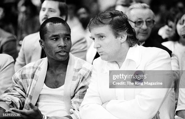 Sugar Ray Leonard talks with Donald Trump before the fight between Mike Tyson and Michael Spinks at the Convention Hall on June 27, 1988 in Atlantic...