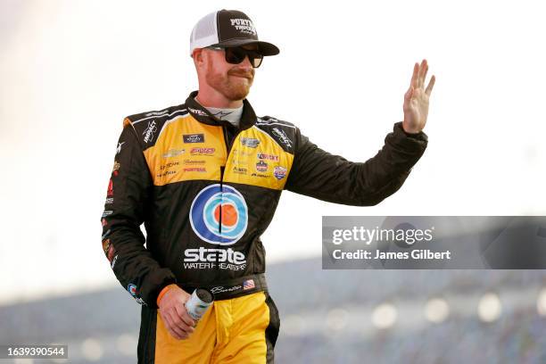 Jeb Burton, driver of the State Water Heaters/PURYEAR Chevrolet, waves to fans as he walks onstage during driver intros prior to the NASCAR Xfinity...