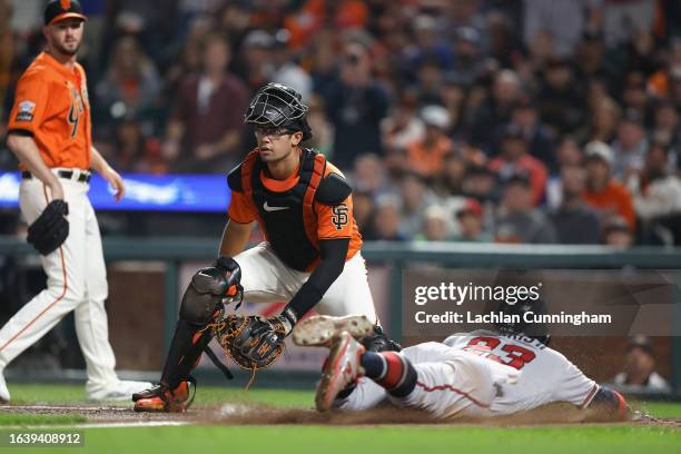 Michael Harris II of the Atlanta Braves past catcher Blake Sabol of the San Francisco Giants to score on a sacrifice fly ball by Matt Olson in the...