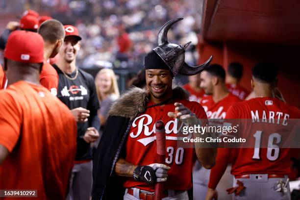 Will Benson of the Cincinnati Reds celebrates in the dugout after hitting a grand slam during the ninth inning against the Arizona Diamondbacks at...