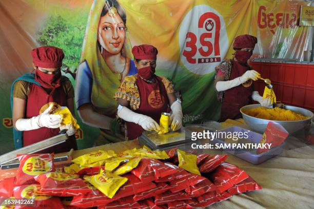 Indian women from the Rural Distribution Network India, from the Self Employed Women's Association , package spices at an agricultural processing...