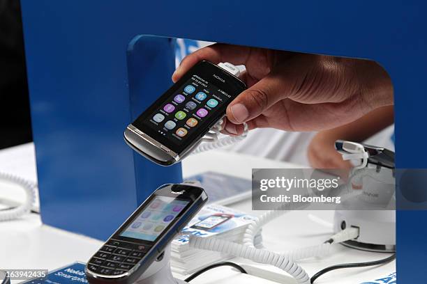 Nokia Asha 311, top, and Nokia Asha 300, smartphones are seen during a promotional event by Nokia Oyj in Maponya Mall in Soweto, South Africa, on...