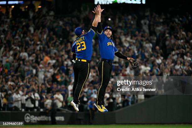 Ty France of the Seattle Mariners and Eugenio Suarez celebrate after the game against the Kansas City Royals at T-Mobile Park on August 25, 2023 in...