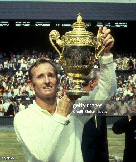 Rod Laver of Australia holds the trophy aloft after his victory in the Men's Singles event at the Lawn Tennis Championships at Wimbledon in London. \...