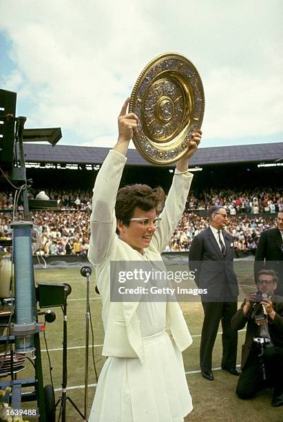 Billie Jean King of the USA holds the trophy aloft after her victory in the Women's Singles event at the Lawn Tennis Championships at Wimbledon in...