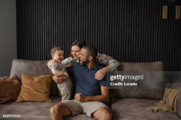 modern fatherhood lifestyle at home for diverse family - familie stockfoto's en -beelden