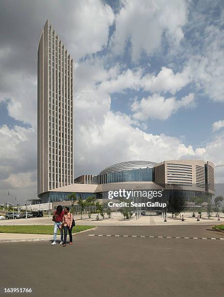 People walk past the headquarters complex of the African Union , which was a gift by the government of China and completed in 2012, on March 18, 2013...