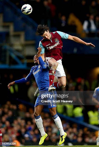 Andy Carroll of West Ham challenges John Obi Mikel of Chelsea during the Barclays Premier League match between Chelsea and West Ham United at...