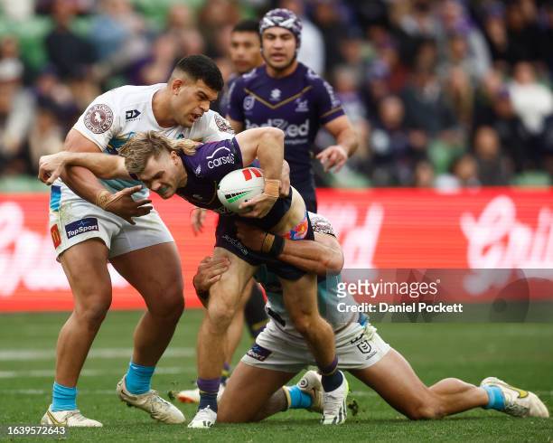 Ryan Papenhuyzen of the Storm is tackled during the round 26 NRL match between Melbourne Storm and Gold Coast Titans at AAMI Park on August 26, 2023...