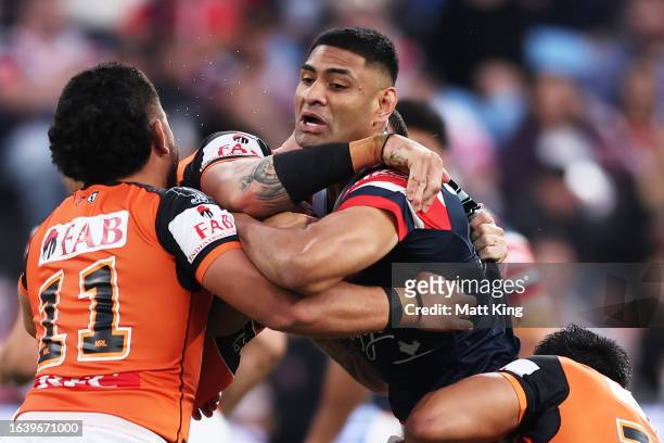 Daniel Tupou of the Roosters is tackled during the round 26 NRL match between Sydney Roosters and Wests Tigers at Allianz Stadium on August 26, 2023...