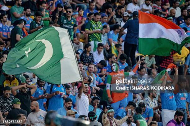 Fans wave India's and Pakistan's national flags during the Asia Cup 2023 one-day international cricket match between India and Pakistan at the...