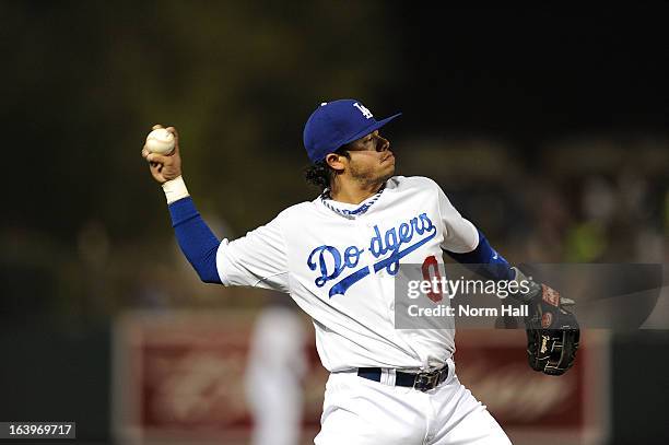 Alfredo Amezaga of the Los Angeles Dodgers throws the ball to first base against the Kansas City Royals on March 15, 2013 in Glendale, Arizona.