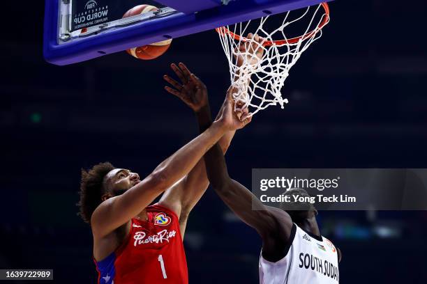 George Conditt of Puerto Rico is blocked on a dunk attempt by Majok Deng of South Sudan in the first quarter during the FIBA Basketball World Cup...