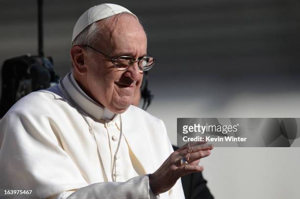 Pope Francis waves to the crowd from the papamobile during his inauguration mass at St Peter's square on March 19, 2013 at the Vatican. World leaders...