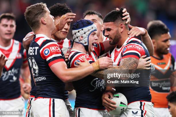 Terrell May of the Roosters celebrates with team mates after scoring a try during the round 26 NRL match between Sydney Roosters and Wests Tigers at...