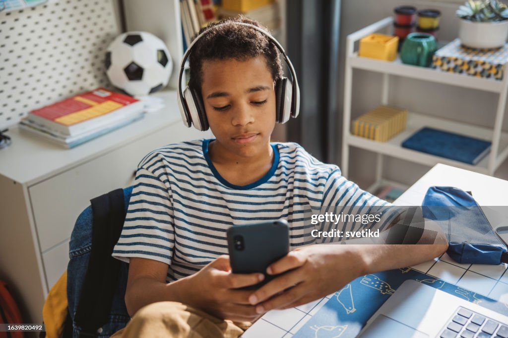 Teenage boy studding at home