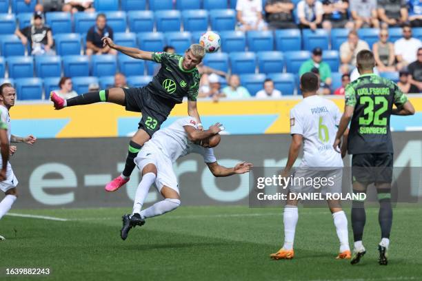 Wolfsburg's Danish forward Jonas Wind and Hoffenheim's German defender John Anthony Brooks vie for the ball during the German first division...
