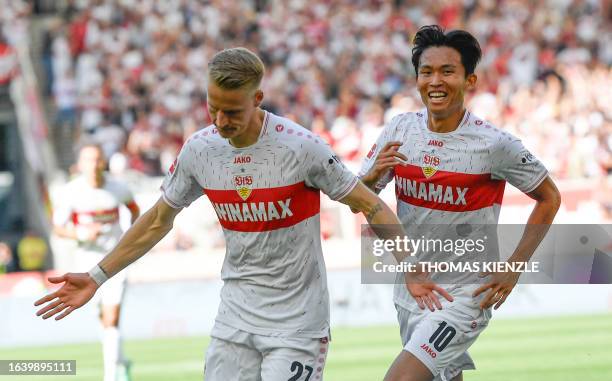 Stuttgart's German midfielder Chris Fuehrich celebrates his 1-0 with Stuttgart's South Korean midfielder Wooyeong Jeong during the German first...