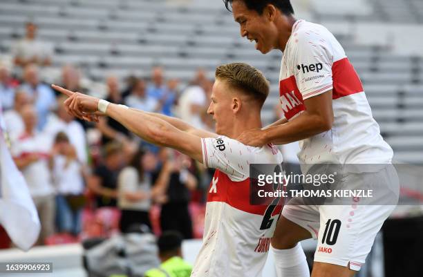 Stuttgart's German midfielder Chris Fuehrich celebrates his 1-0 with Stuttgart's South Korean midfielder Wooyeong Jeong during the German first...