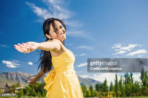 carefree girl twirling around - yellow dress stock pictures, royalty-free photos & images