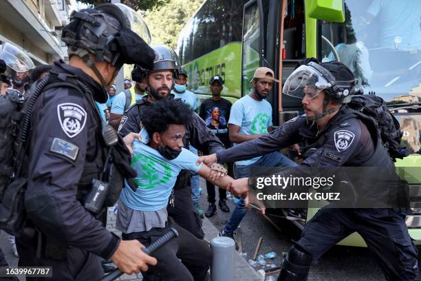 Members of Israel's security forces clash with Eritrean asylum-seekers protesting an event organised by Eritrea's government in the coastal city of...