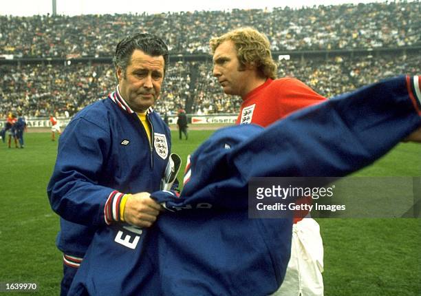 May 1972: England captain Bobby Moore has his tracksuit taken by trainer Harold Shepherdson before the UEFA European Championship Quarter-final match...