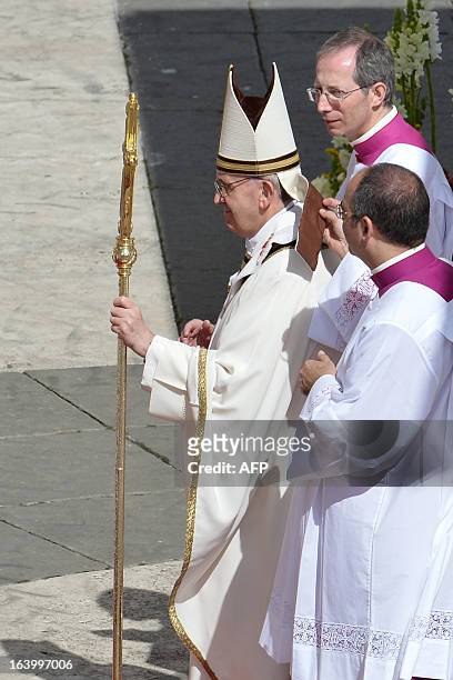An assistant puts back the Mitre of Pope Francis during his grandiose inauguration mass on March 19, 2013 at St Peter's square at the Vatican. Pope...
