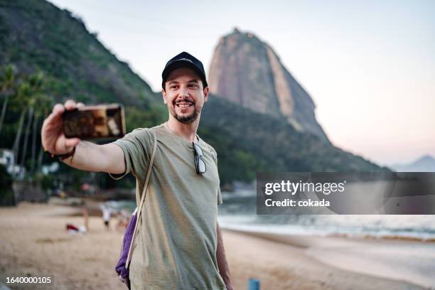 man taking a selfie at rio de janeiro - praia vermelha rio de janeiro stock pictures, royalty-free photos & images