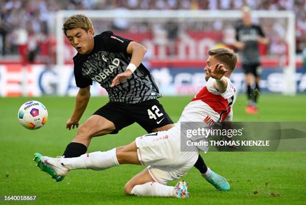 Freiburg's Japanese forward Ritsu Doan and Stuttgart's German defender Maximilian Mittelstaedt vie for the ball during the German first division...