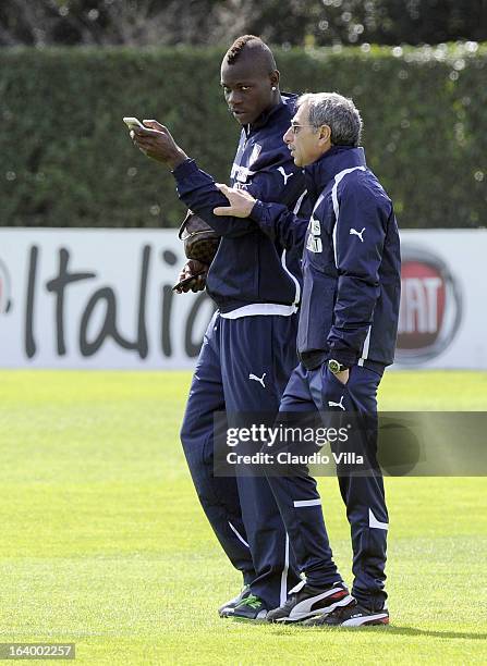Mario Balotelli of Italy and Doctor Enrico Castellacci during a training session at Coverciano on March 19, 2013 in Florence, Italy.
