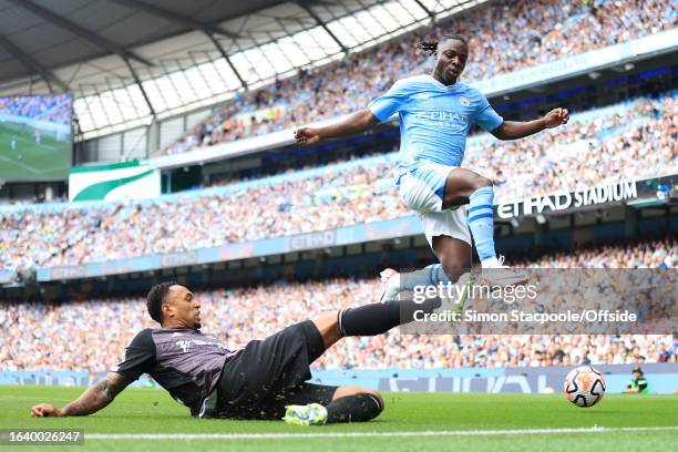 Kenny Tete of Fulham battles with Jeremy Doku of Manchester City during the Premier League match between Manchester City and Fulham FC at Etihad...