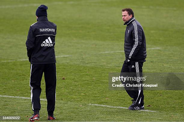 Head coach Sascha Lewandowski looks at team coach Sami Hyypiae during the Bayer 04 Leverkusen training session on March 19, 2013 in Leverkusen,...