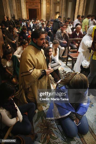 Argentinians gather in Metropolitan Cathedral while watching to watch a live broadcast of the installation of Pope Francis in Saint Peter's Square on...