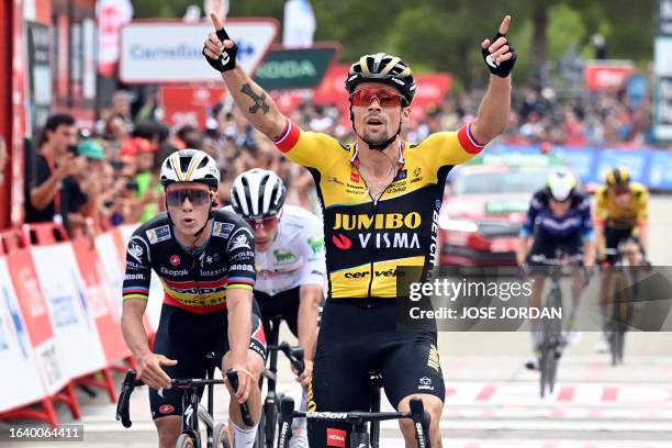 Stage winner Team Jumbo's Slovenian rider Primoz Roglic celebrates followed by Team Quick Step's Belgian rider Remco Evenepoel as he crosses the...